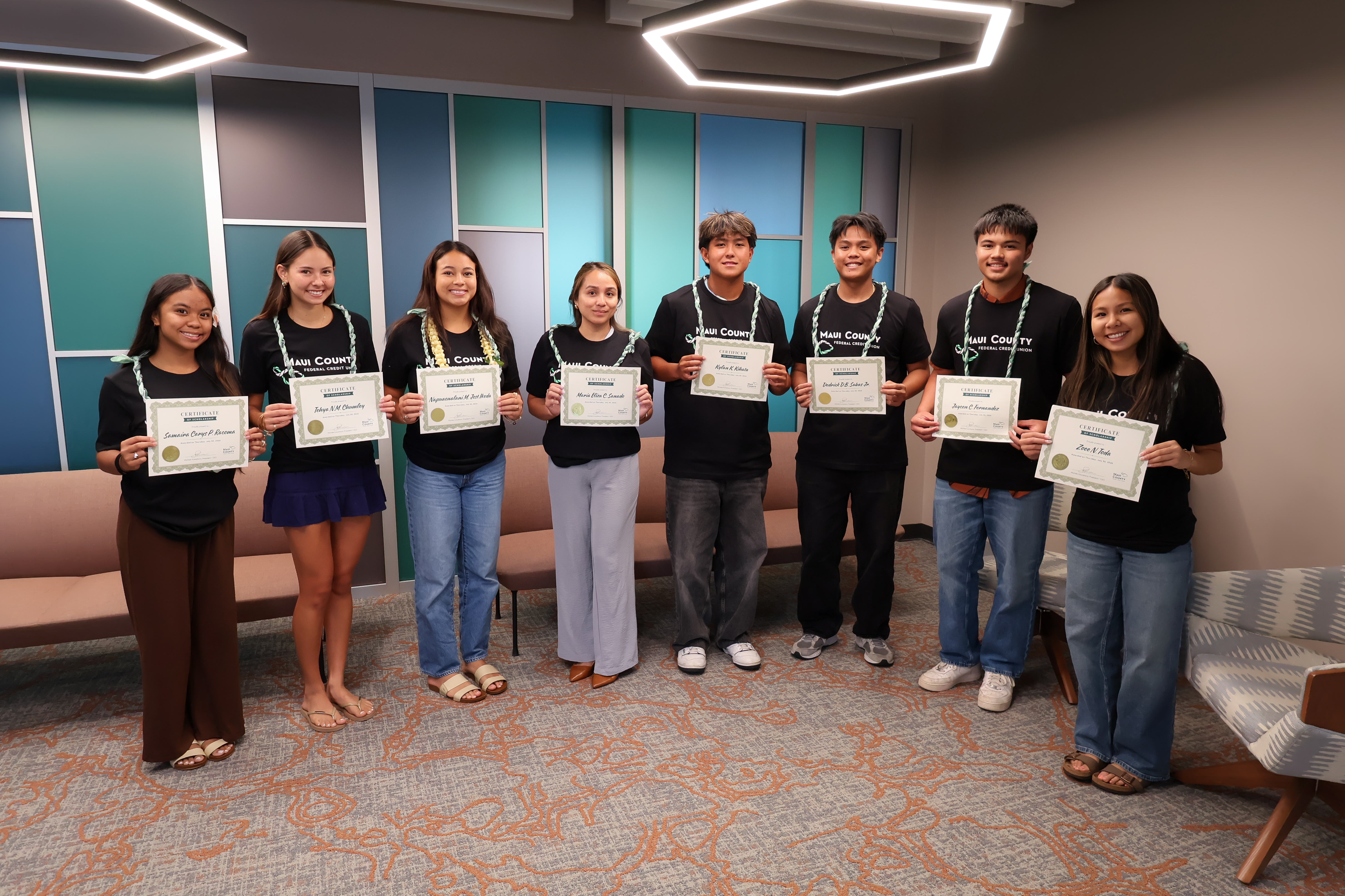 Students holding scholarship certificates.