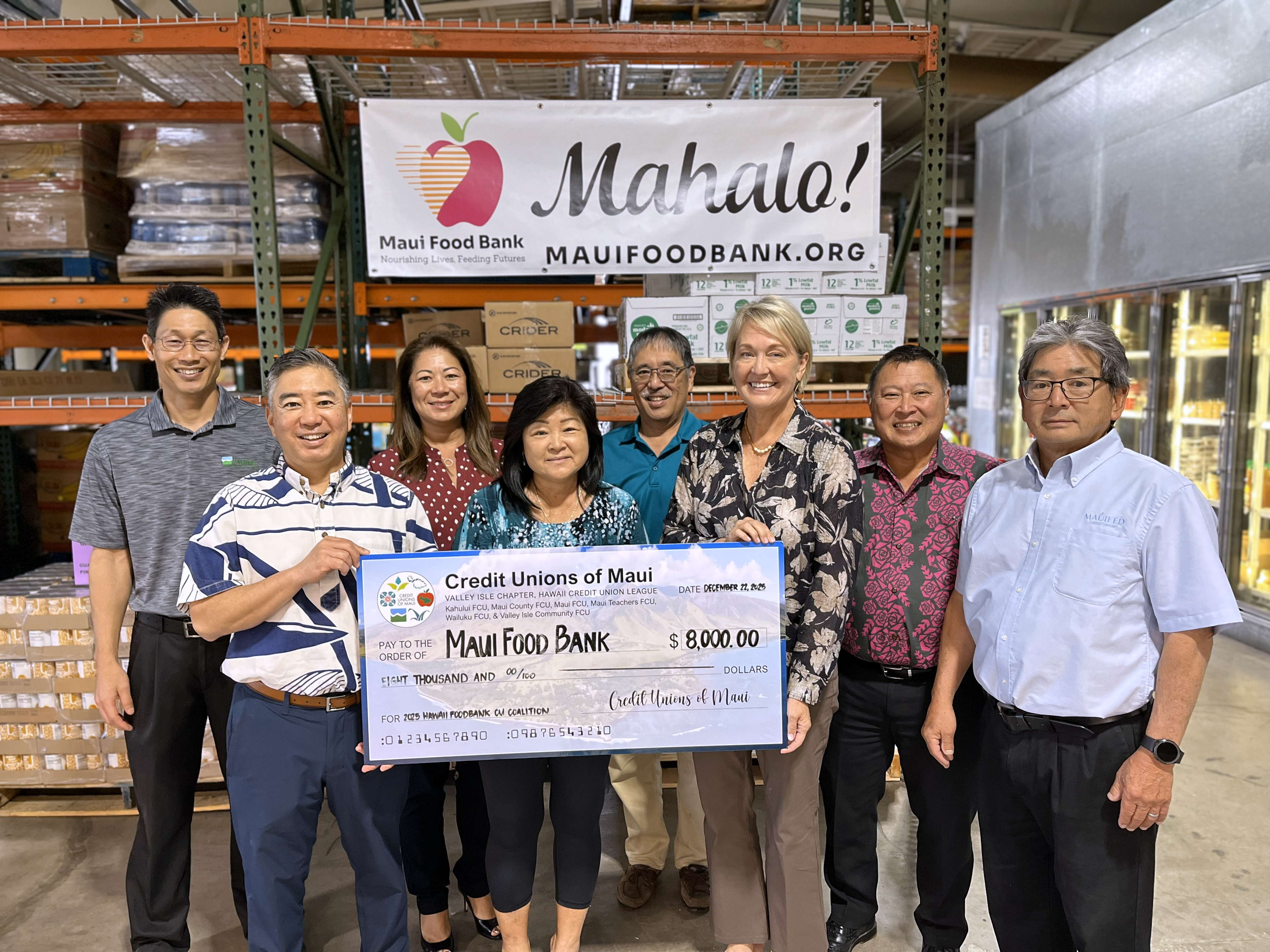 People holding Maui Food Bank check.