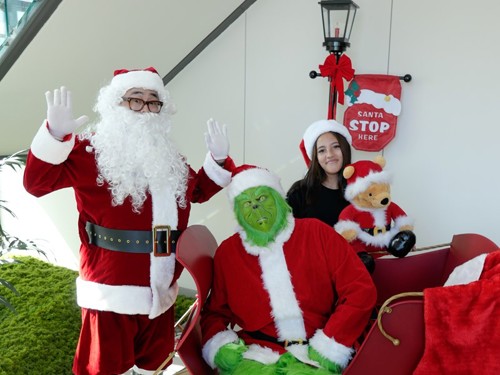 Santa, grinch and child.