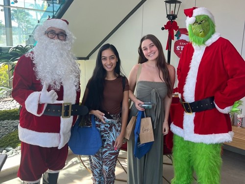 Santa and grinch with teens.